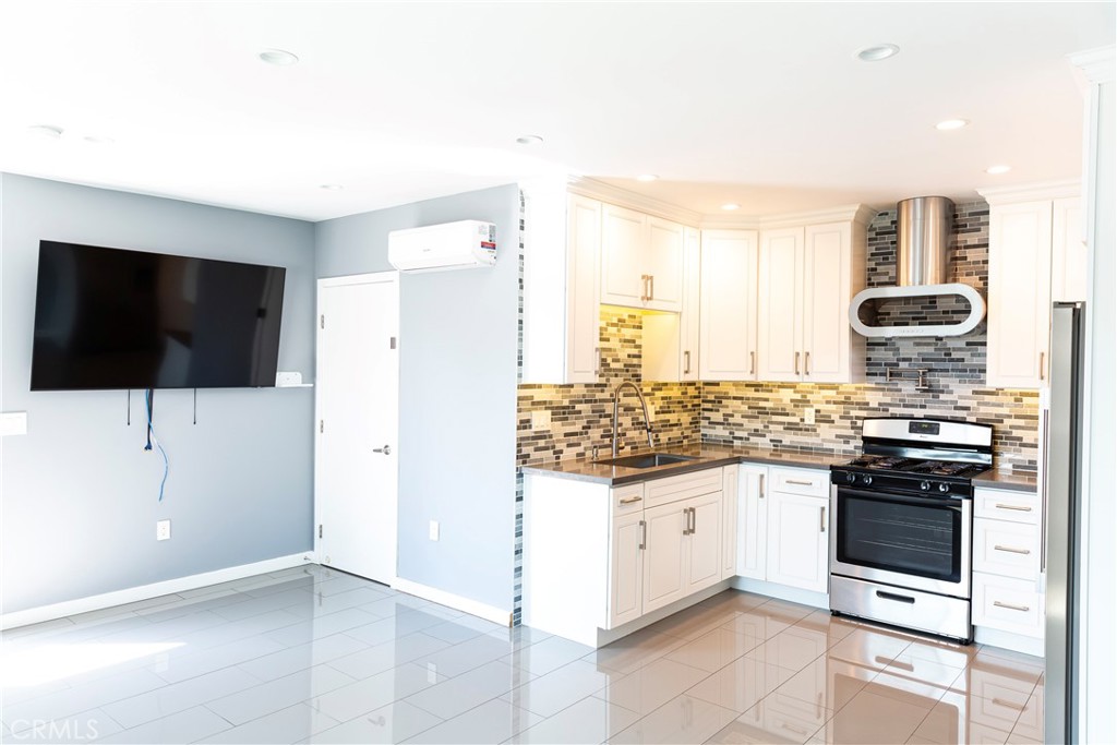 3155 Brookhill Street La Crescenta, CA 91214 - Photo 25 of 28 a kitchen with stainless steel appliances kitchen island granite countertop a stove and a sink