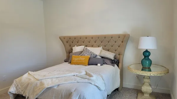 a bedroom with a bed and chair