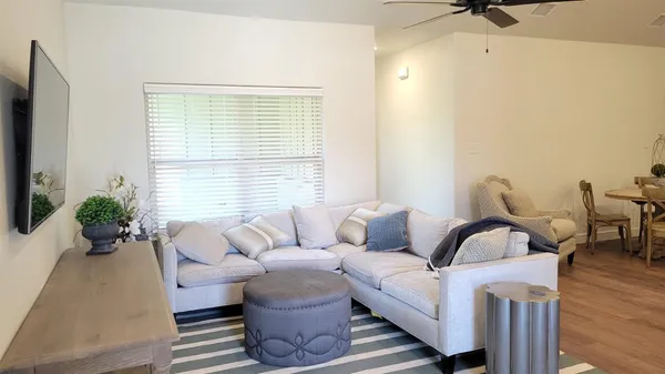 a living room with furniture and wooden floor