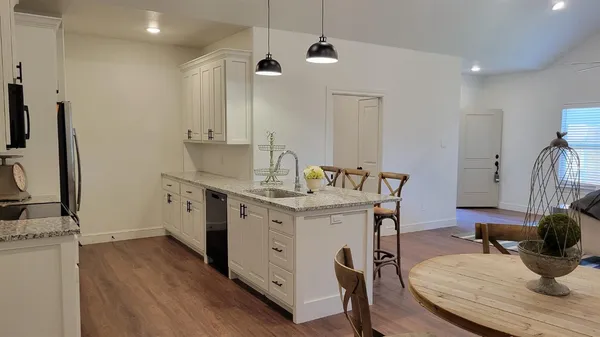 a kitchen with a sink appliances and cabinets