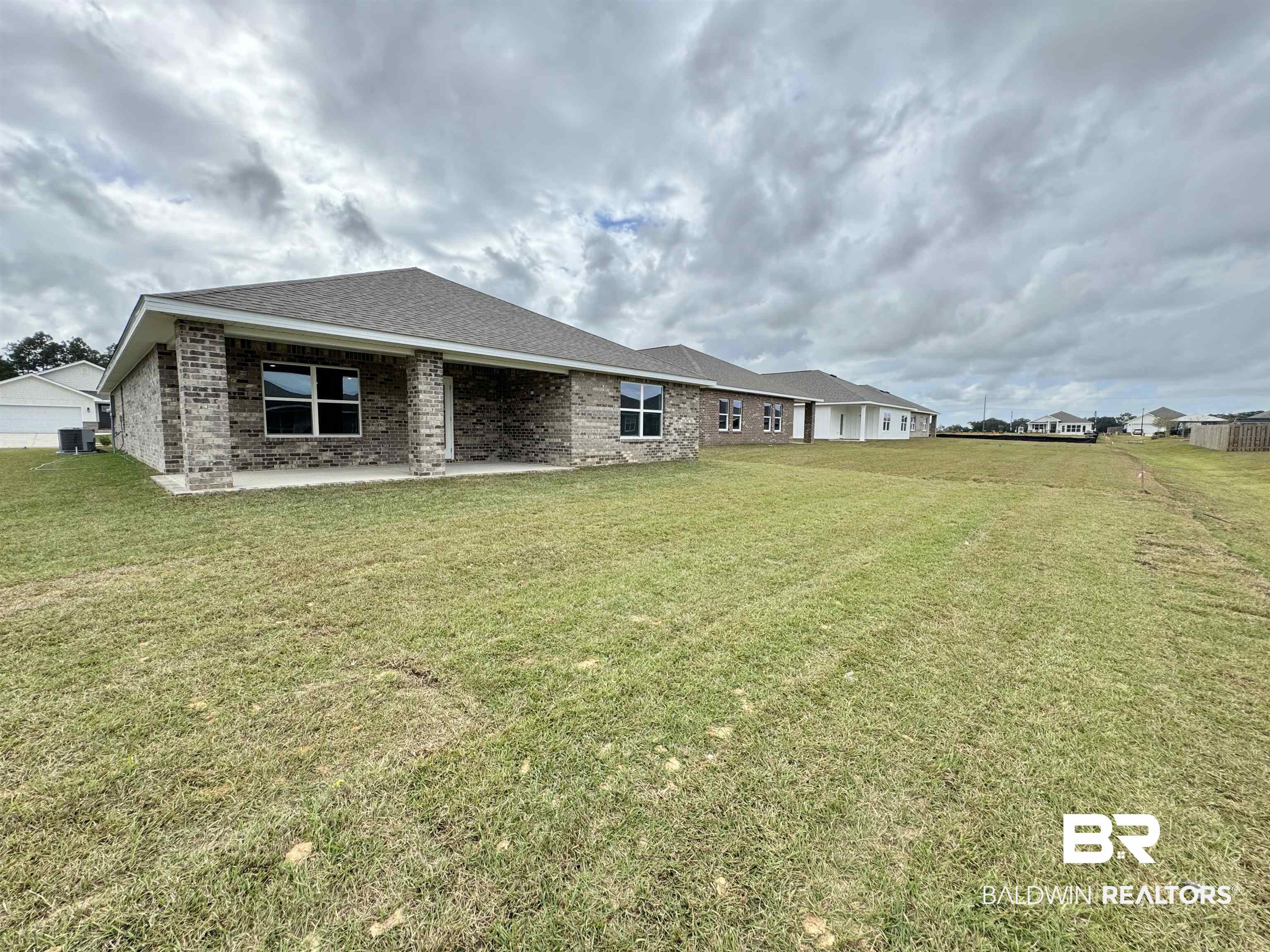 1244 Hayward Loop Foley, AL 36535 - Photo 31 of 38 Rear view of house featuring a yard and central air condition unit