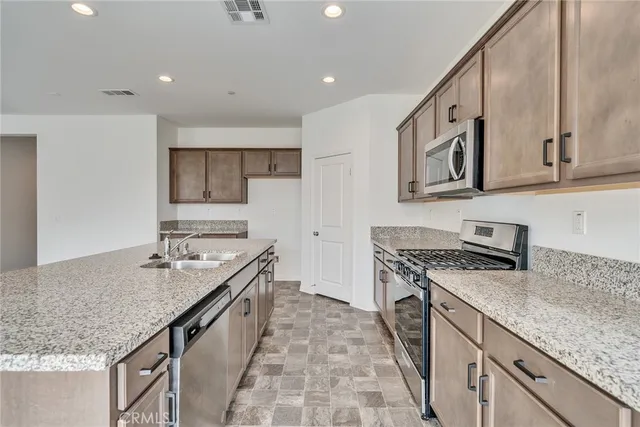 a kitchen with a stove sink and cabinets