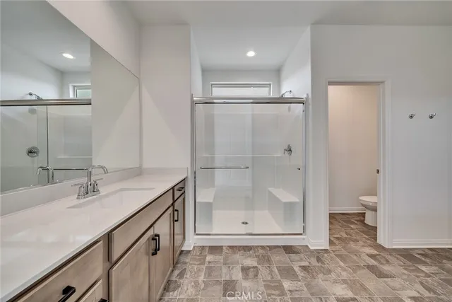 a bathroom with a granite countertop sink mirror and shower