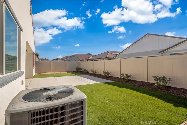 a backyard of a house with table and chairs