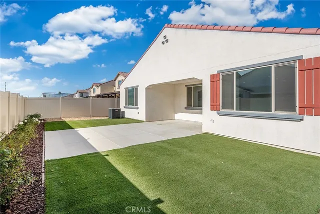 a view of an white house with a yard
