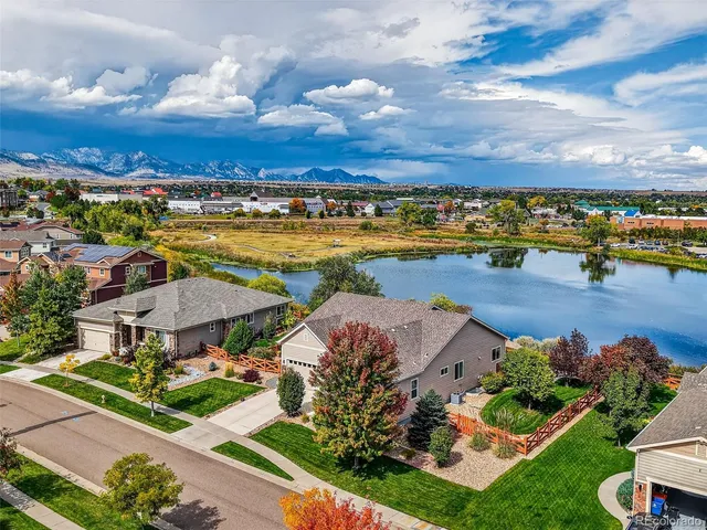 a view of a lake with a houses in the background