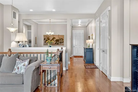 a view of a patio with a dining table and chairs with wooden floor