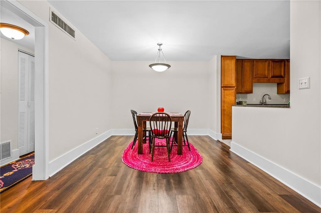 1468 Briarwood Road Northeast, Unit 401 Brookhaven, GA 30319 - Photo 11 of 26 a view of a room with wooden floor table and chairs