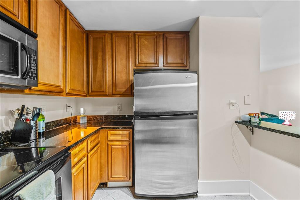1468 Briarwood Road Northeast, Unit 401 Brookhaven, GA 30319 - Photo 15 of 26 a kitchen with a sink a refrigerator and cabinets