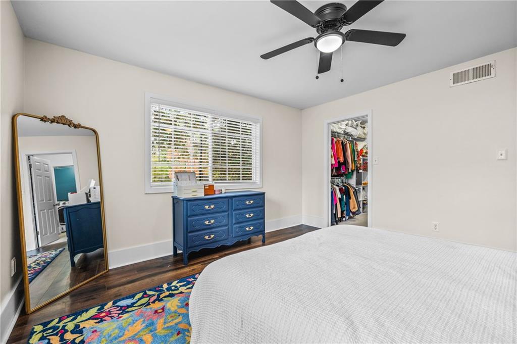 1468 Briarwood Road Northeast, Unit 401 Brookhaven, GA 30319 - Photo 18 of 26 a bedroom with a bed and a chandelier