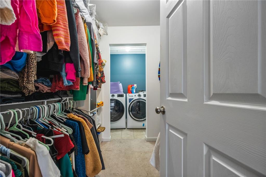 1468 Briarwood Road Northeast, Unit 401 Brookhaven, GA 30319 - Photo 19 of 26 a view of walk in closet with clothes and shoes
