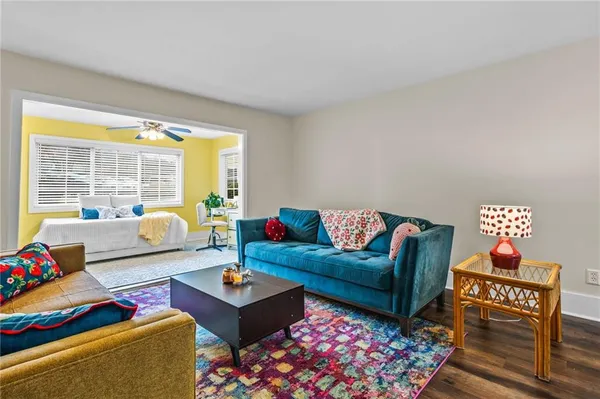 a living room with furniture and a floor to ceiling window