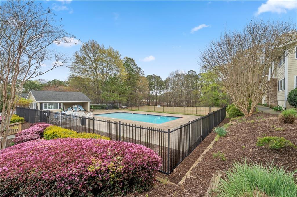 1468 Briarwood Road Northeast, Unit 401 Brookhaven, GA 30319 - Photo 25 of 26 a view of a house with backyard and swimming pool