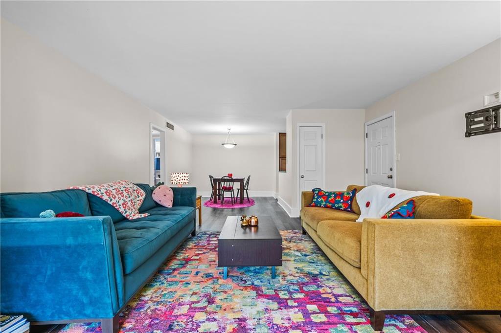 1468 Briarwood Road Northeast, Unit 401 Brookhaven, GA 30319 - Photo 6 of 26 a living room with furniture and a couch