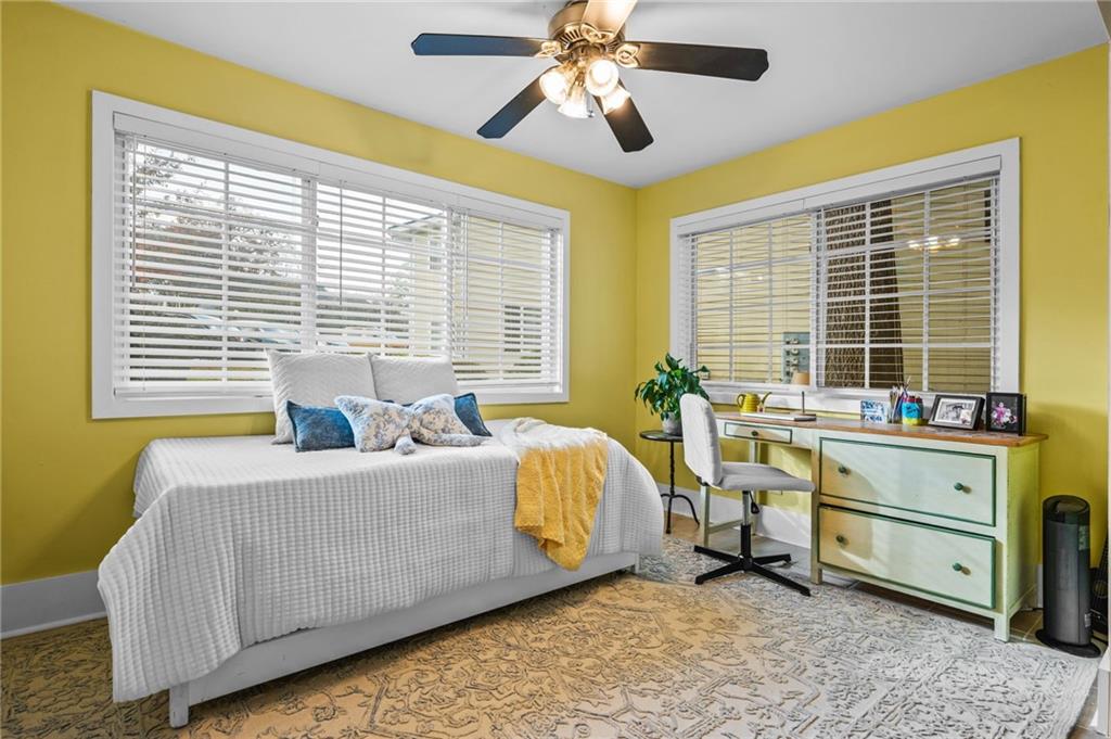 1468 Briarwood Road Northeast, Unit 401 Brookhaven, GA 30319 - Photo 7 of 26 a bedroom with a bed and a chandelier