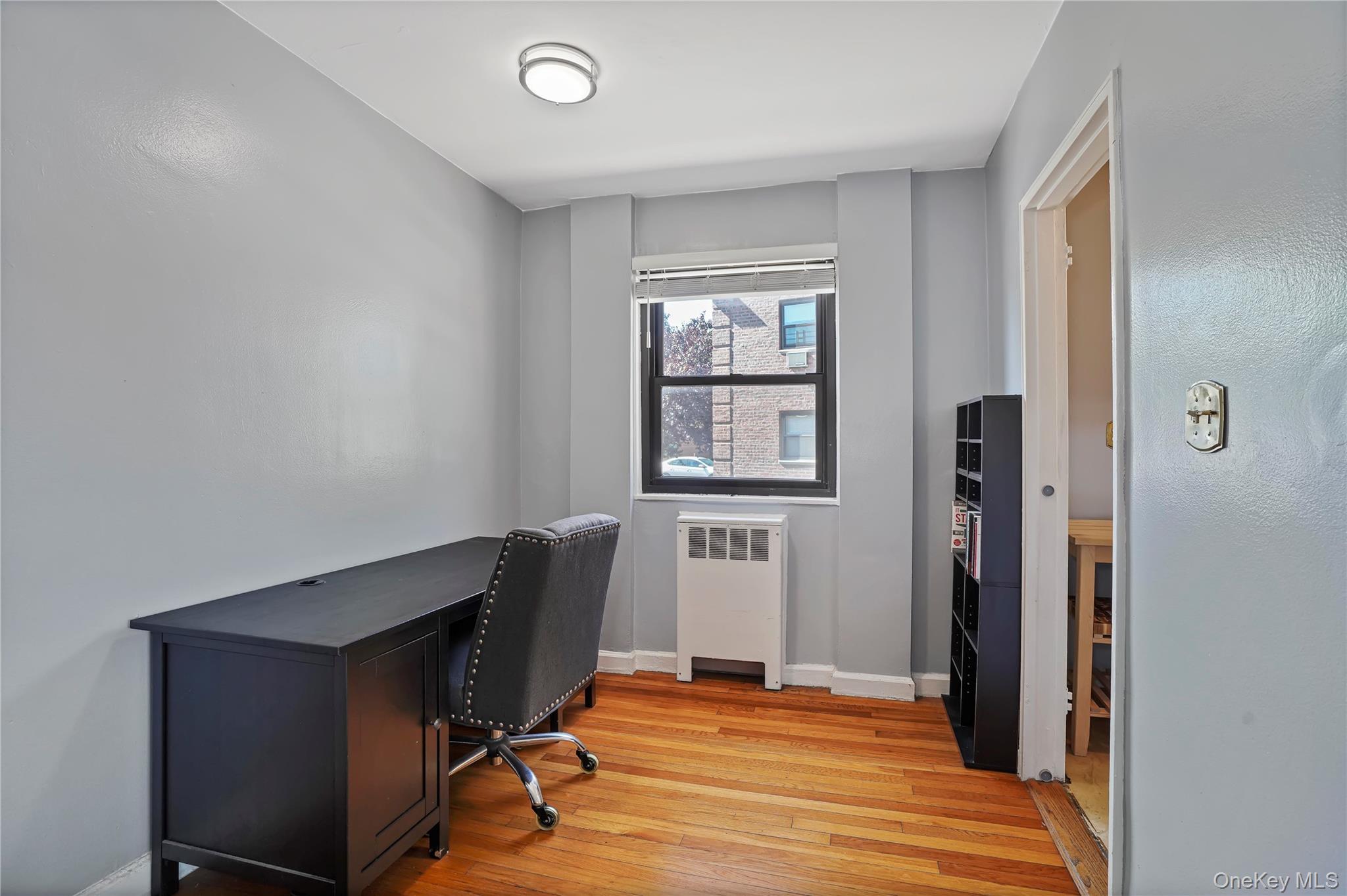 84-18 155th Avenue, Unit 1R Queens, NY 11414 - Photo 13 of 26 a workspace with wooden floor and windows