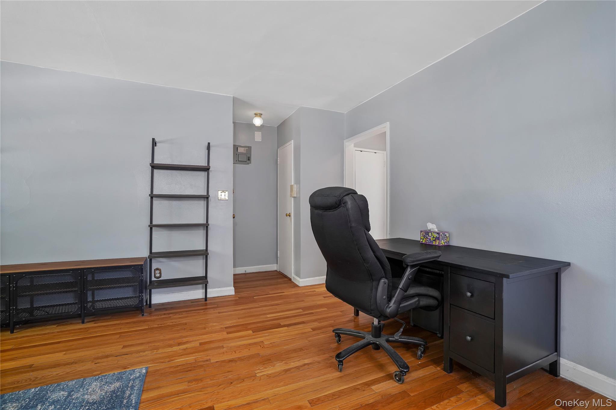 84-18 155th Avenue, Unit 1R Queens, NY 11414 - Photo 15 of 26 a view of a workspace with furniture and wooden floor
