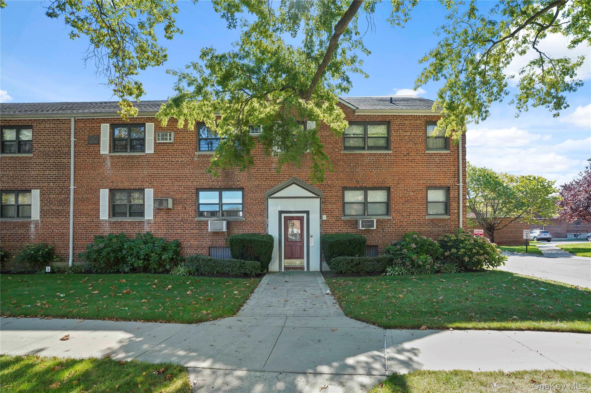 84-18 155th Avenue, Unit 1R Queens, NY 11414 - Photo 22 of 26 front view of a house with a yard