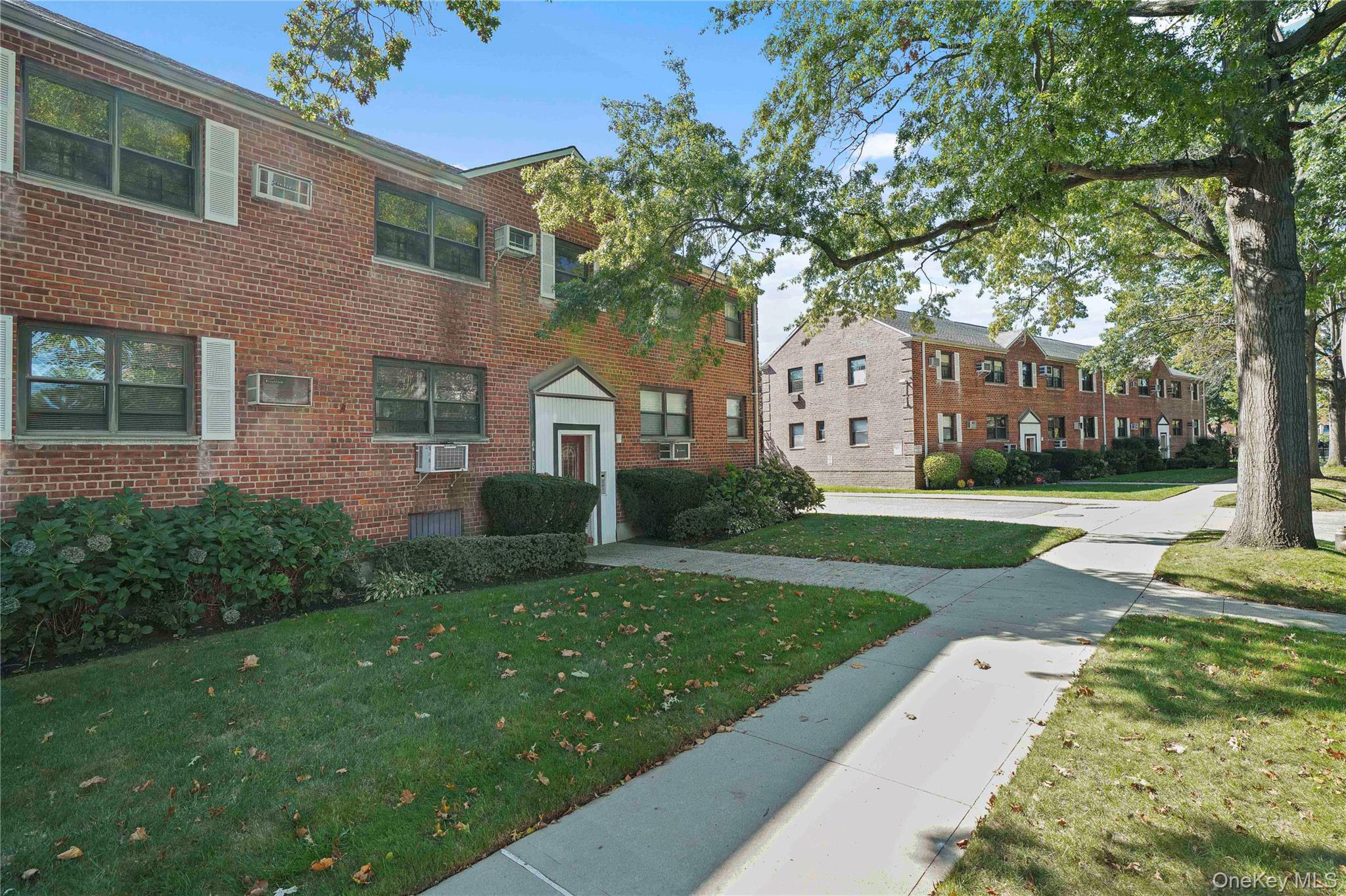 84-18 155th Avenue, Unit 1R Queens, NY 11414 - Photo 24 of 26 a front view of a house with a yard