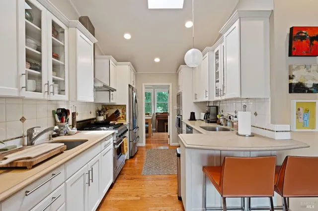 a kitchen with a sink stove and cabinets