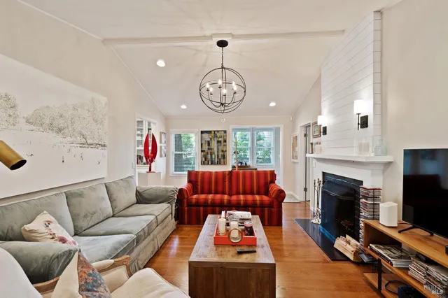 a living room with furniture a fireplace and a flat screen tv