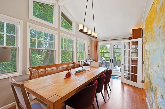 a view of a dining room with furniture large windows and wooden floor