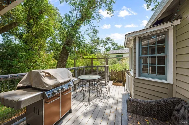 a view of a patio with table and chairs and wooden floor