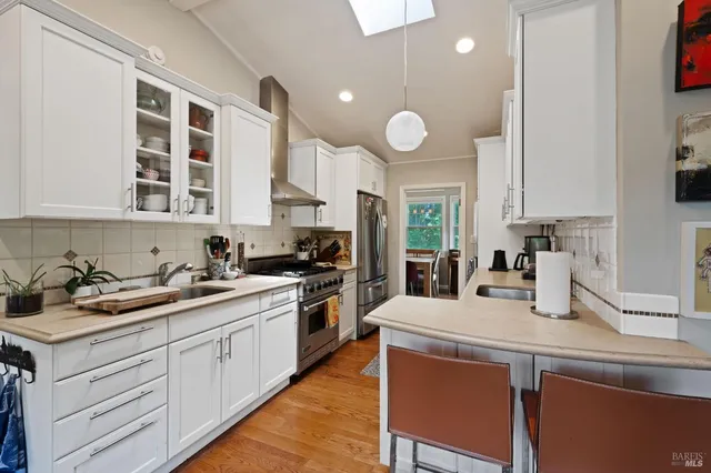 a kitchen with a sink stove and cabinets