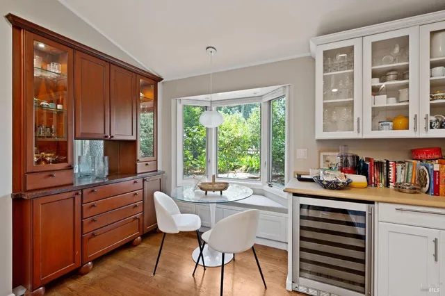 a dining room with a window and chairs