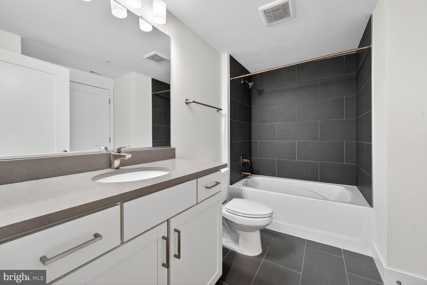 50 Florida Avenue Northeast, Unit 209 Washington, DC 20002 - Photo 15 of 29 a bathroom with a sink a toilet and shower