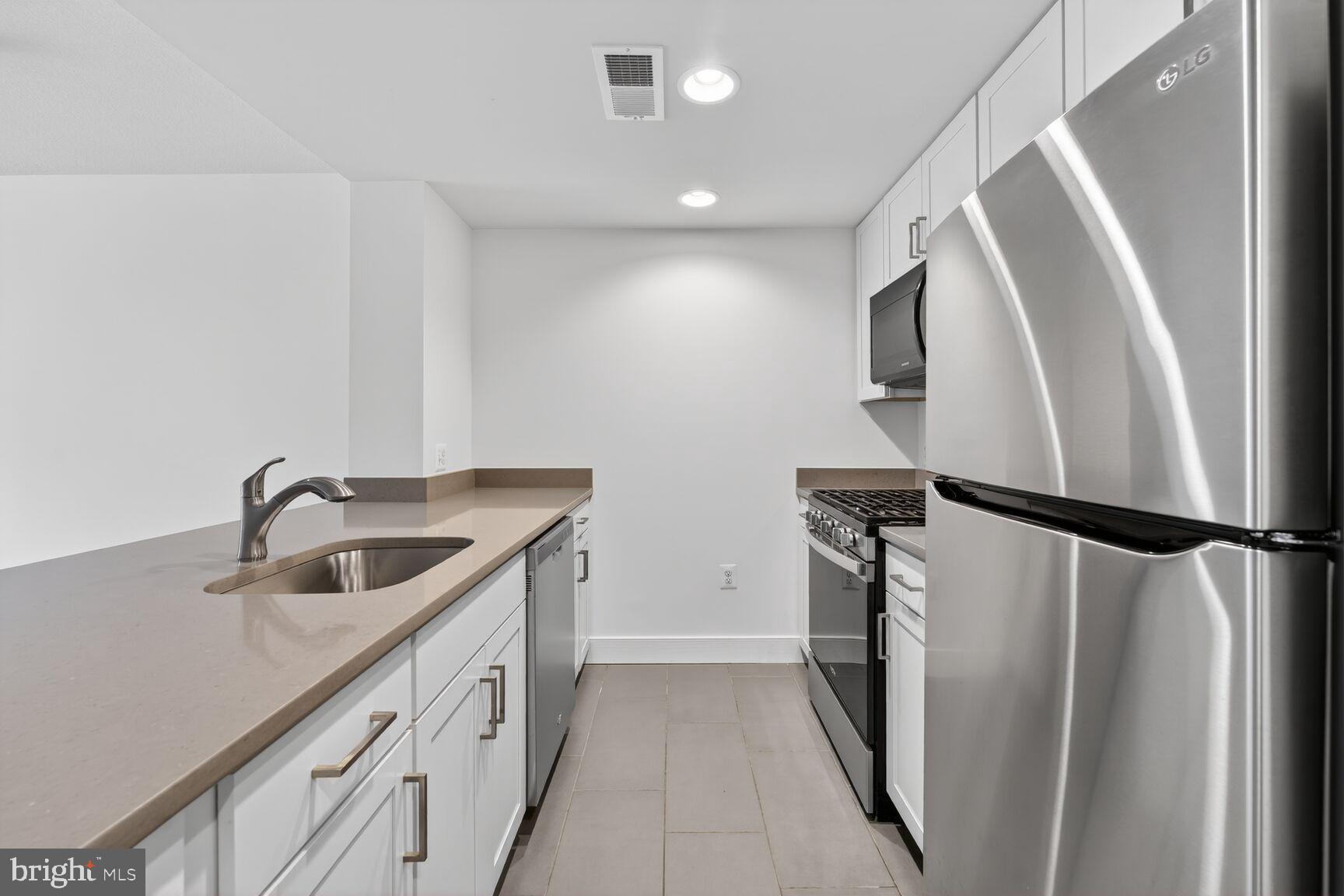50 Florida Avenue Northeast, Unit 209 Washington, DC 20002 - Photo 3 of 29 a kitchen with a refrigerator sink and stove