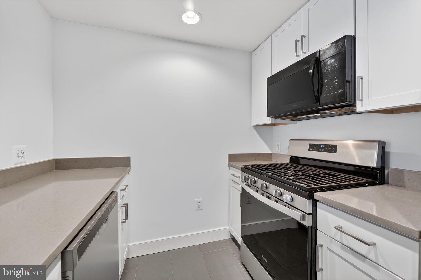 50 Florida Avenue Northeast, Unit 209 Washington, DC 20002 - Photo 4 of 29 a kitchen with granite countertop a stove and a microwave