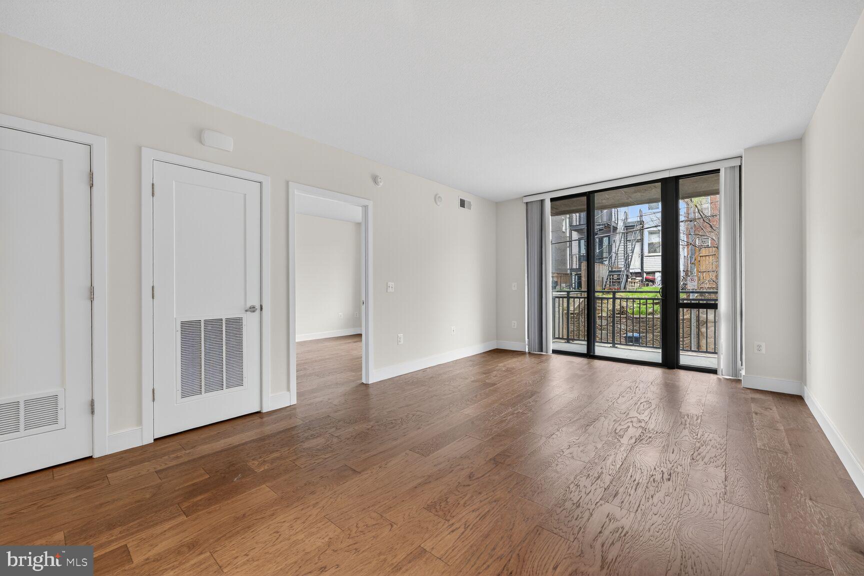 50 Florida Avenue Northeast, Unit 209 Washington, DC 20002 - Photo 7 of 29 a view of an empty room with wooden floor and a window