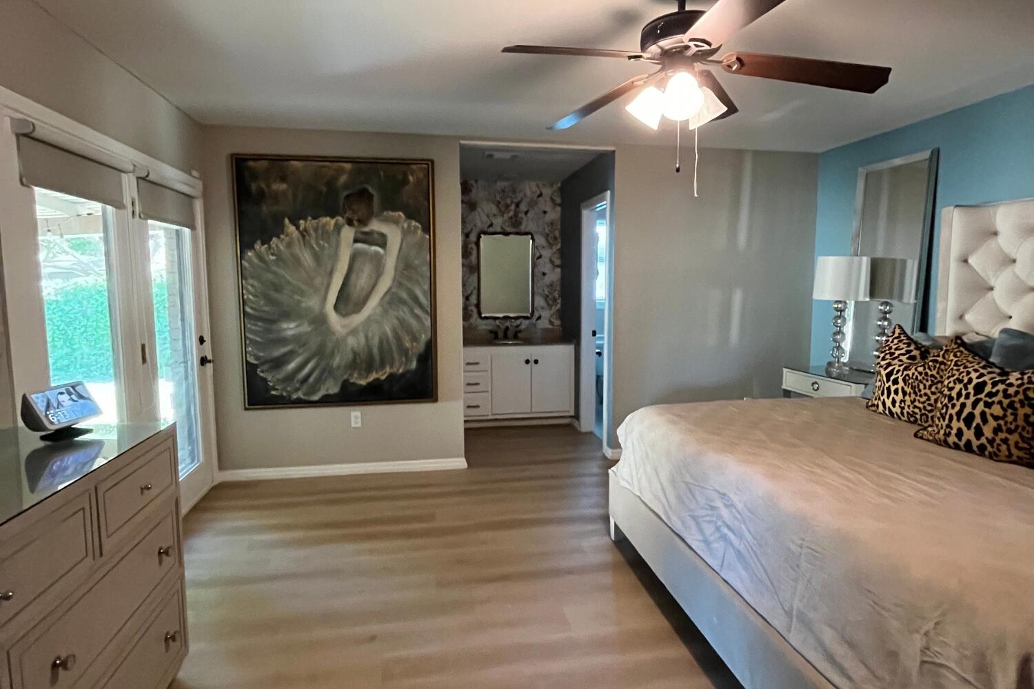 8508 Jordan Drive Lubbock, TX 79423 - Photo 14 of 34 a bedroom with a large bed and a chandelier