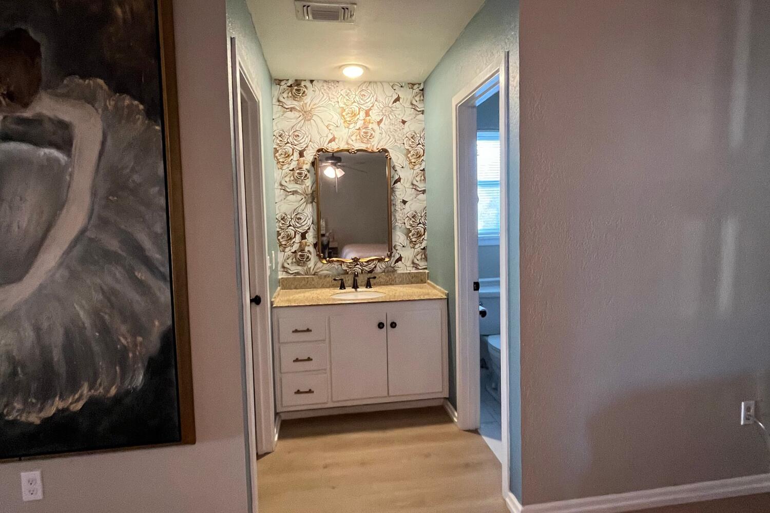 8508 Jordan Drive Lubbock, TX 79423 - Photo 15 of 34 a bathroom with a sink and mirror with shower