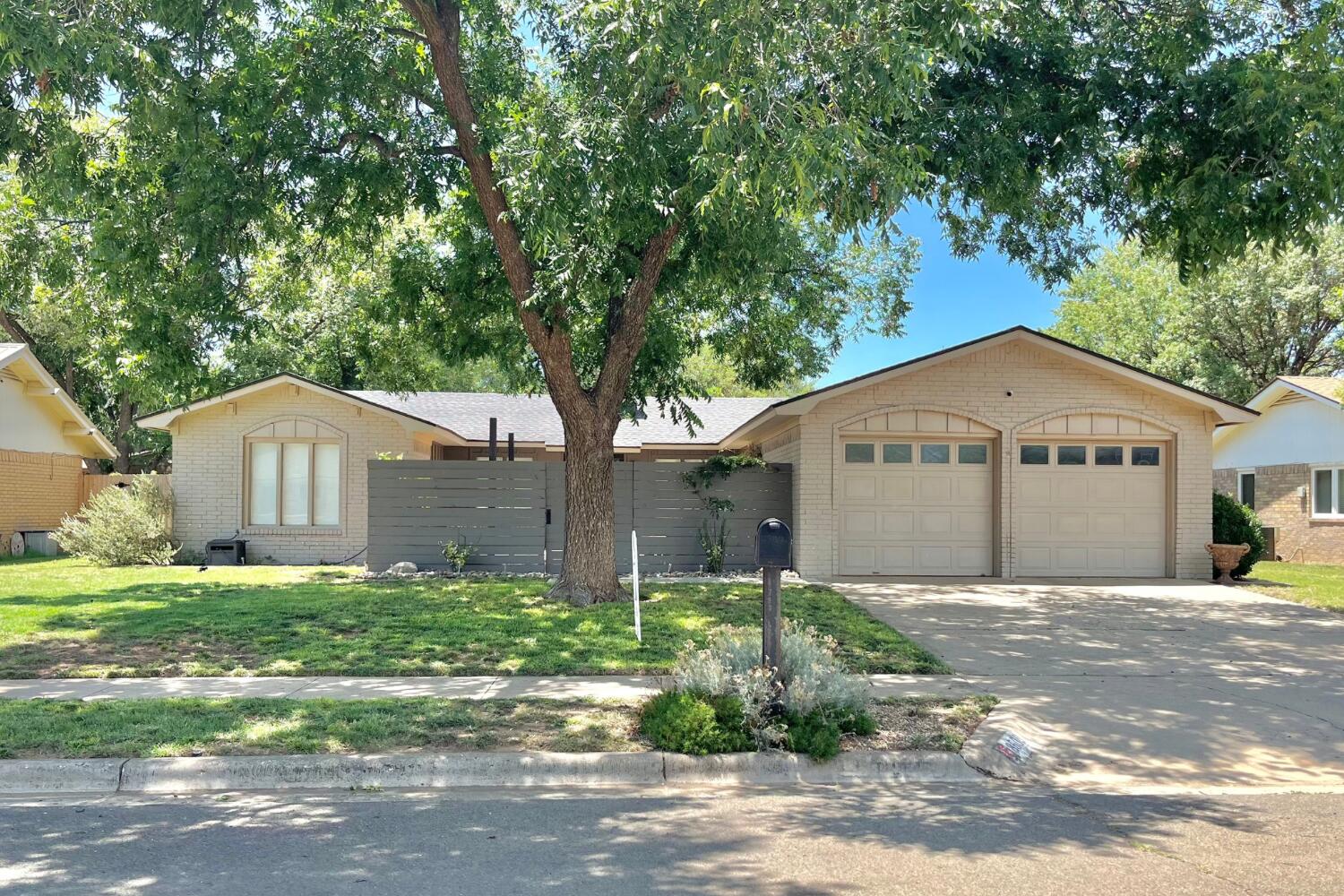 8508 Jordan Drive Lubbock, TX 79423 - Photo 2 of 34 a front view of a house with a yard and garage