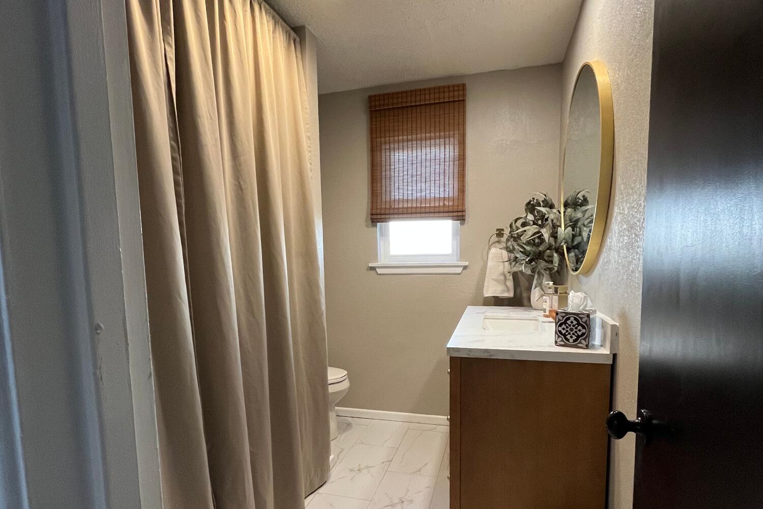 8508 Jordan Drive Lubbock, TX 79423 - Photo 22 of 34 a bathroom with a sink a mirror and a toilet