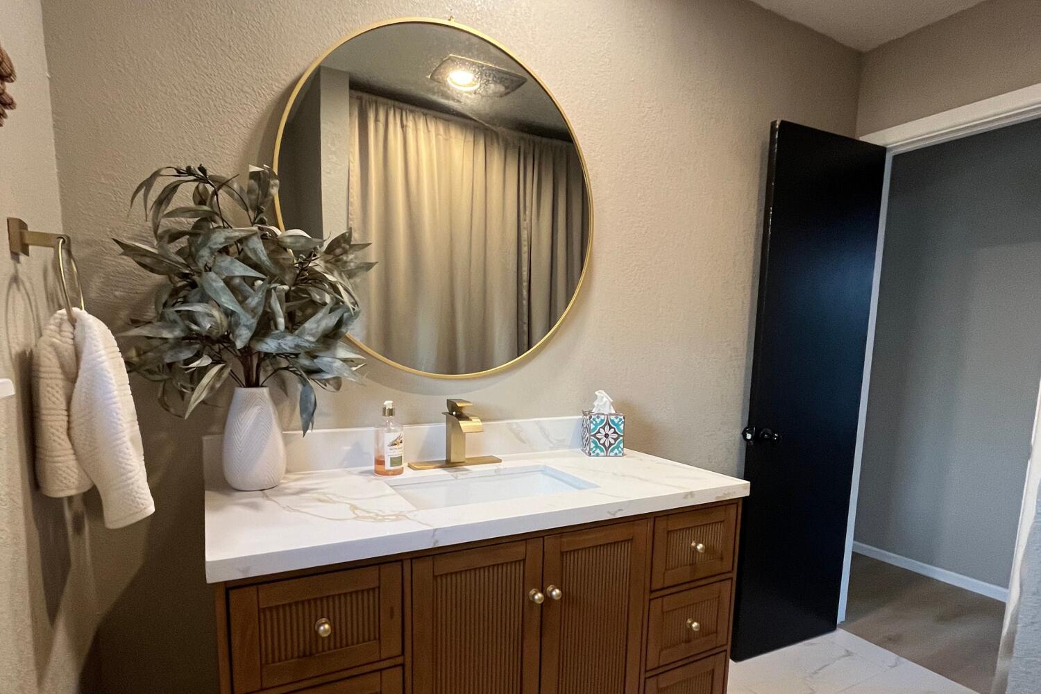 8508 Jordan Drive Lubbock, TX 79423 - Photo 23 of 34 a bathroom with a double vanity sink and a mirror