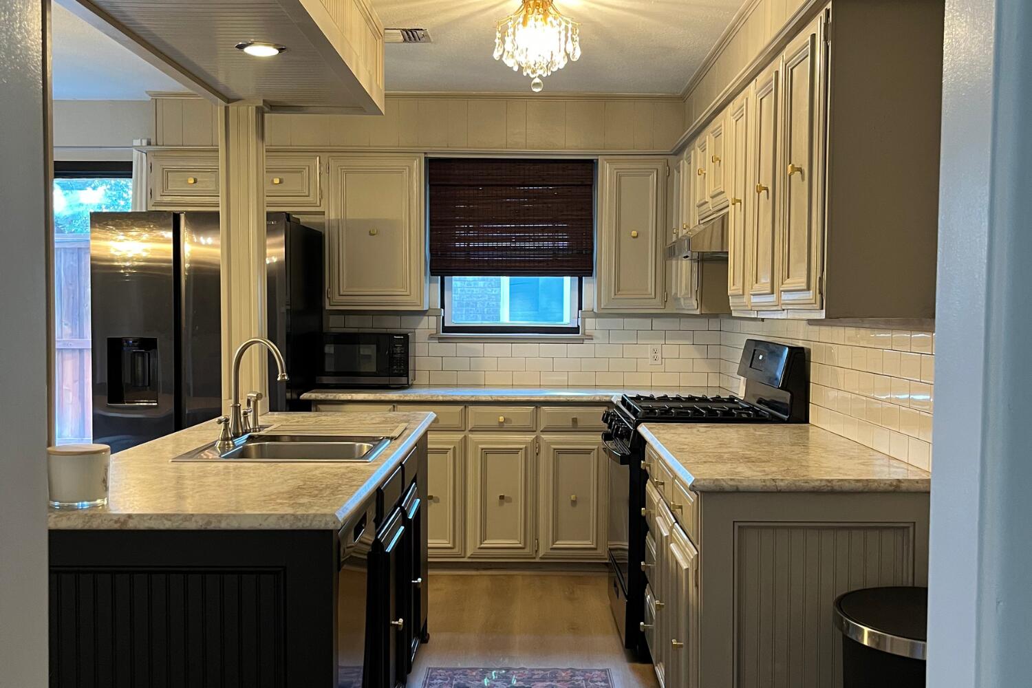 8508 Jordan Drive Lubbock, TX 79423 - Photo 10 of 34 a kitchen with stainless steel appliances granite countertop a sink a stove and a refrigerator