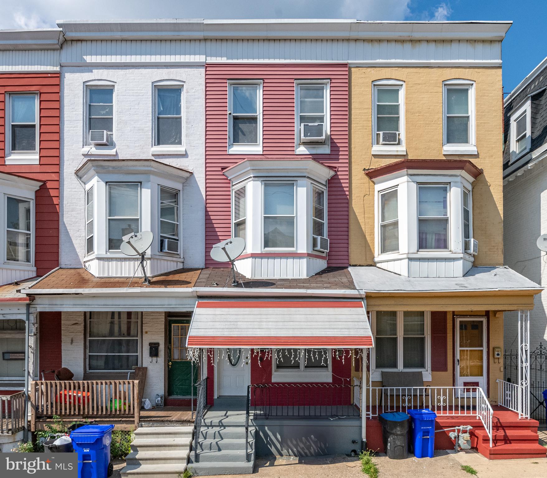 a front view of multi story residential apartment building with a yard