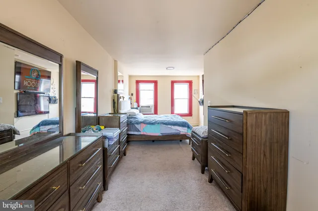 a bedroom with furniture and a window