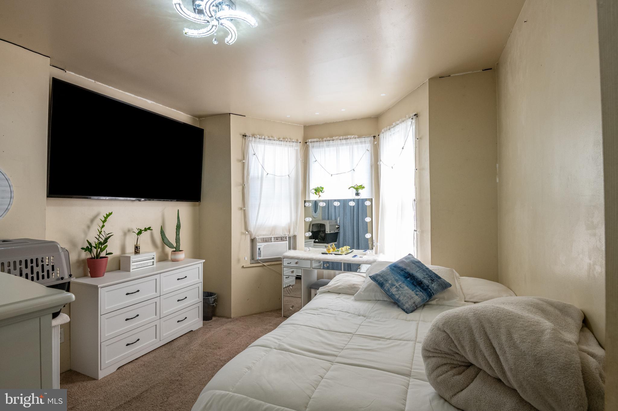 1711 Perkiomen Avenue Reading, PA 19602 - Photo 14 of 20 a bedroom with a bed and a flat screen tv