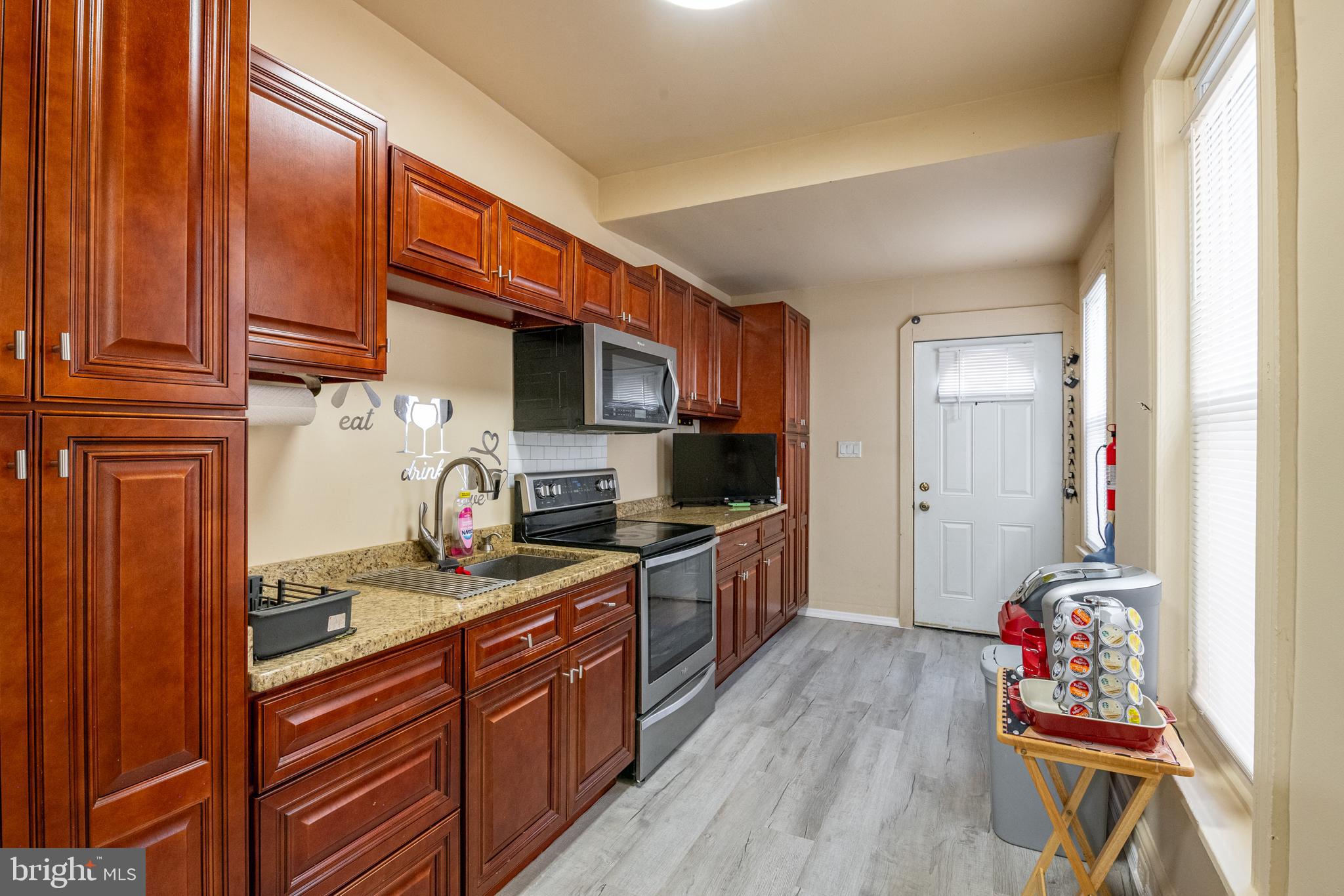 1711 Perkiomen Avenue Reading, PA 19602 - Photo 8 of 20 a kitchen with stainless steel appliances granite countertop a sink stove and cabinets