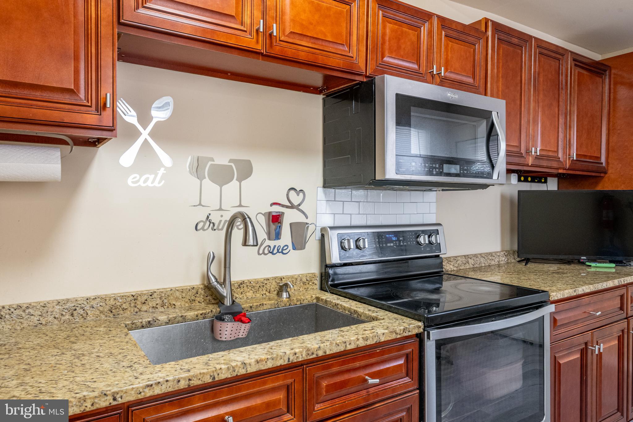 1711 Perkiomen Avenue Reading, PA 19602 - Photo 9 of 20 a kitchen with granite countertop a stove and cabinets