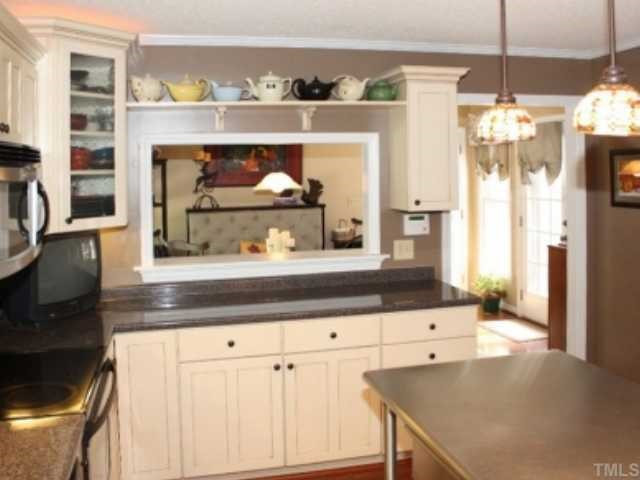 You'll love this kitchen with the pass-through window to the breakfast room. There is a display shelf, and the cabinets are Kraftmaid. Kitchen