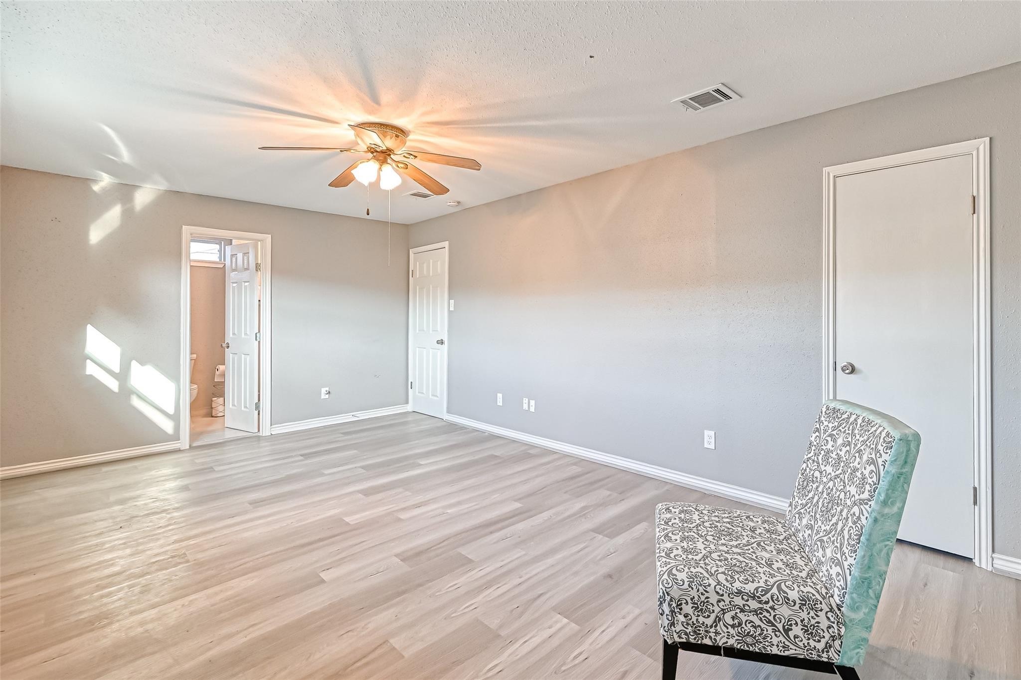 10252 Cottage Field Road Houston, TX 77041 - Photo 7 of 18 a view of an empty room with window and wooden floor