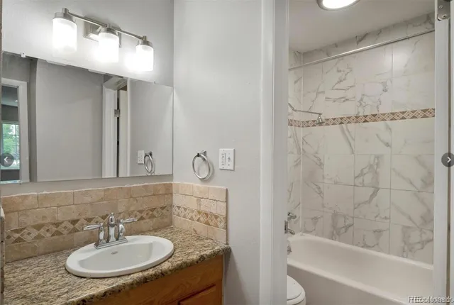 a bathroom with a shower and a bath tub