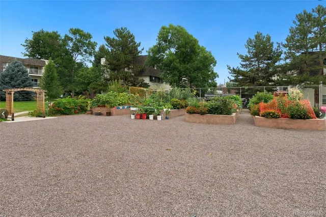 a view of a patio with a table and chairs and potted plants