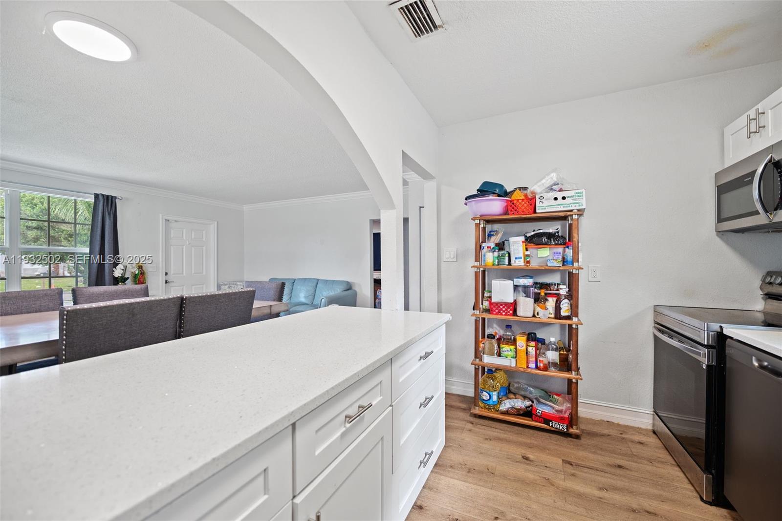 6894 3rd Street Jupiter, FL 33458 - Photo 18 of 29 a living room with furniture and a book shelf