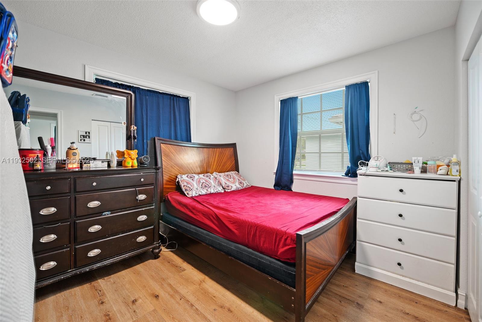 6894 3rd Street Jupiter, FL 33458 - Photo 20 of 29 a bedroom with a bed and a dresser